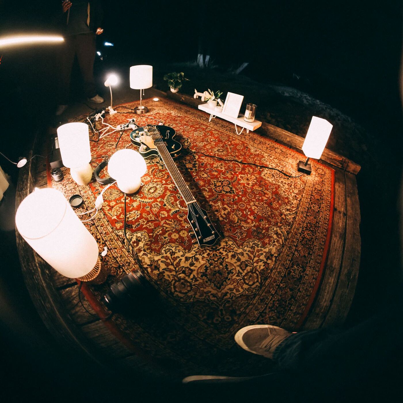 The rug, lamps and guitars from above