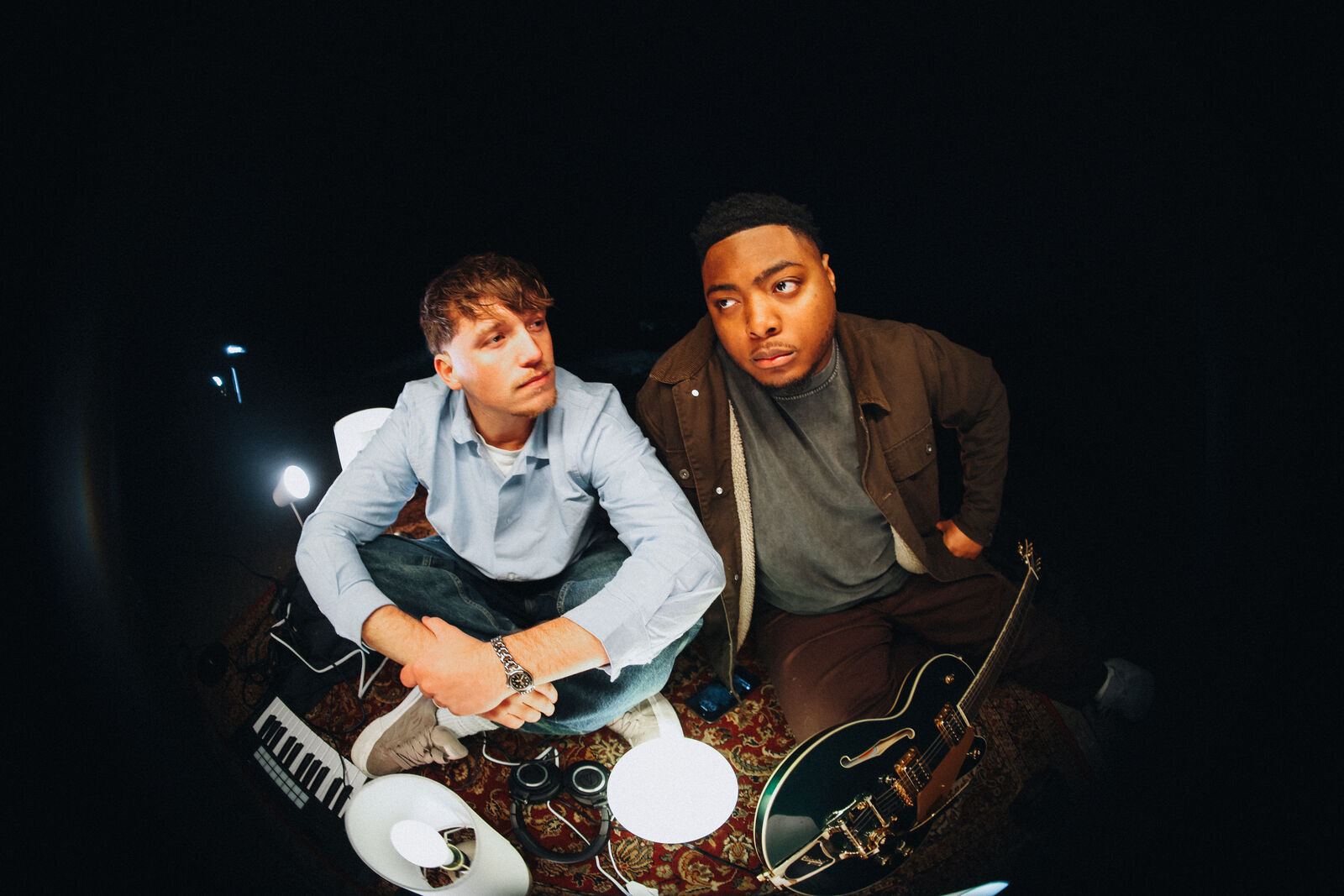 Jude and Sincer on a rug by the lake at night