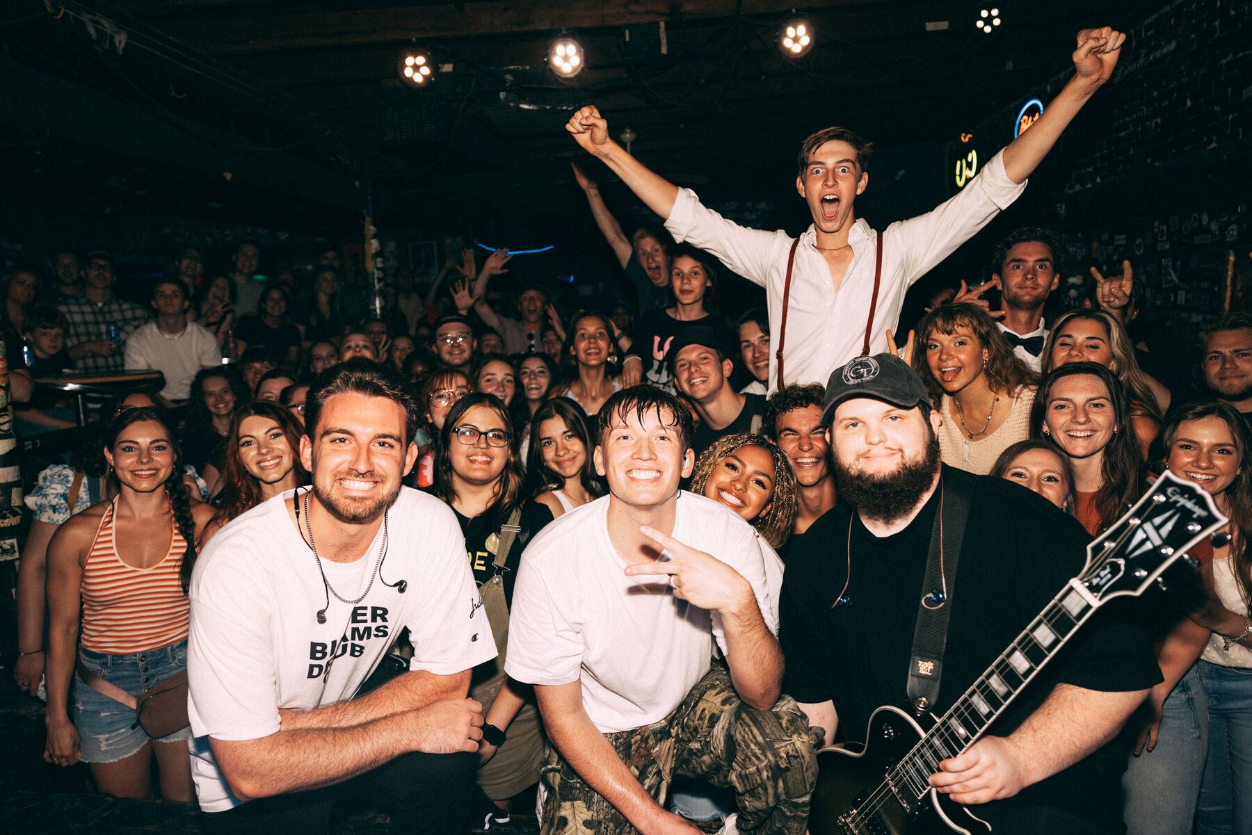 Jude and the band with a crowd of fans, arms in the air