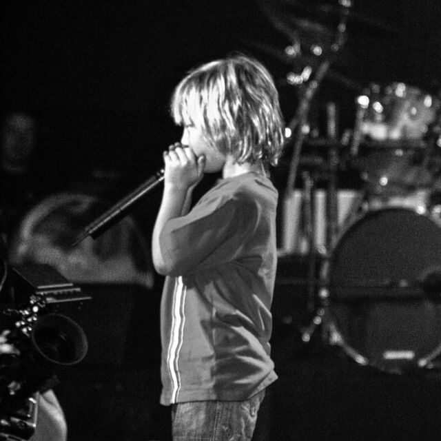 Jude as a kid singing on stage